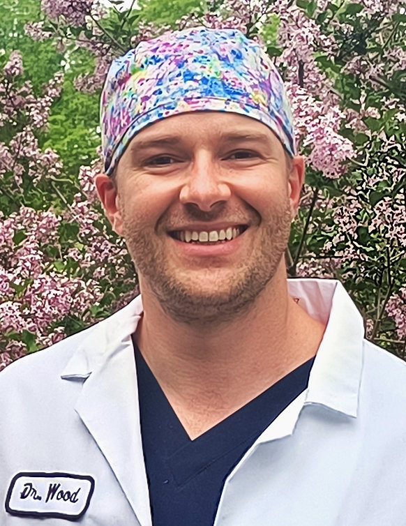 Dr. Chris Wood in surgical cap and white coat